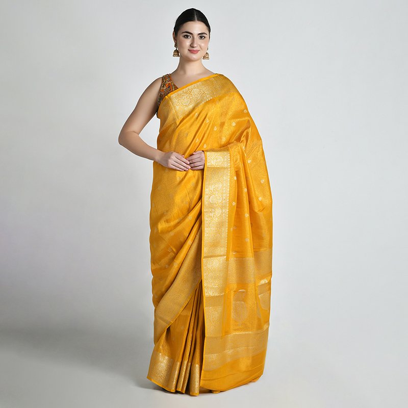 Model draped in mustard silk saree, front pose studio photoshoot by Lohar Studio